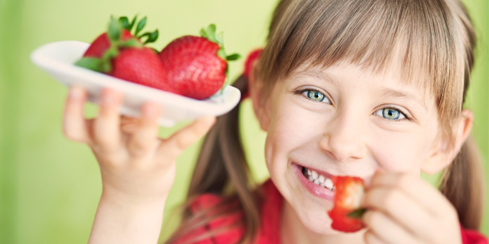 girl eating strawberries