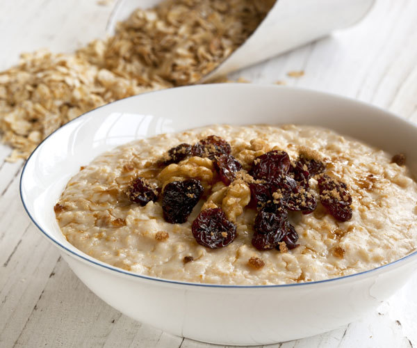 Overloaded oatmeal breakfast recipe with raisins and walnuts.