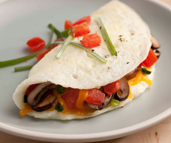 Healthy egg white omelet recipe with mushrooms, tomato, and cheddar cheese.