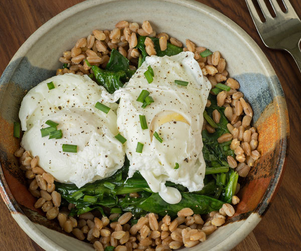 Healthy rice bowl recipe with brown rice, spinach, bok choy, and poached eggs