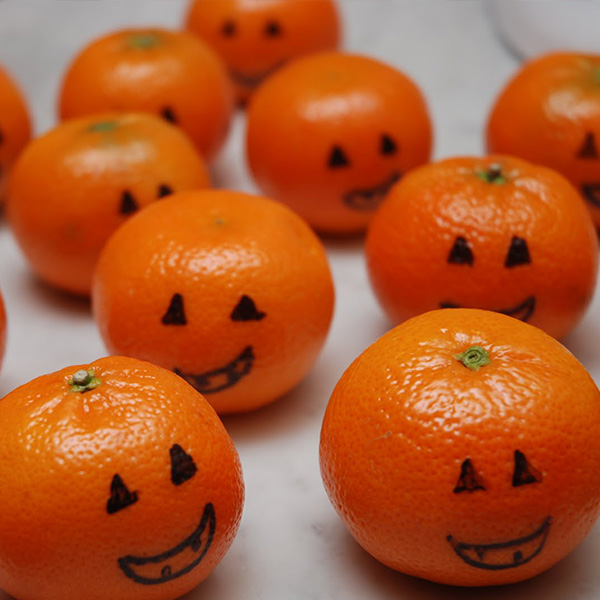 Jack O' Lanterns drawn on clementines Halloween Snack